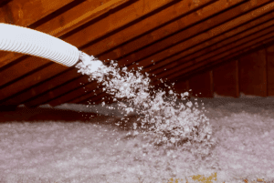 blown cellulose insulation being installed in an attic, provided by Barrie Inspections in Victoria Texas
